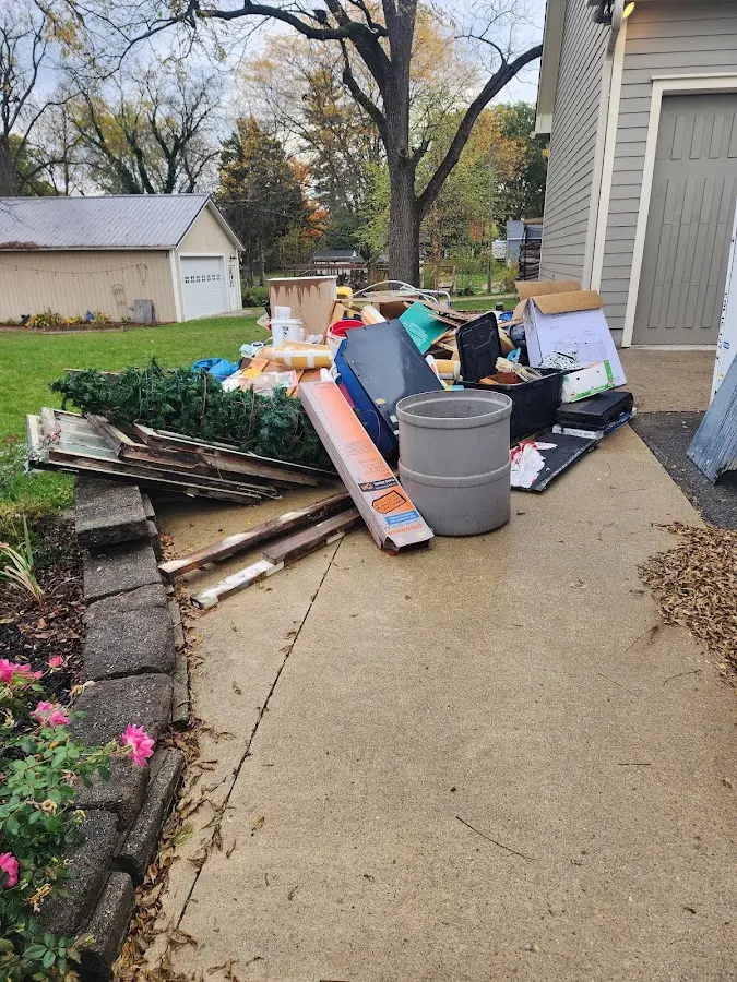 Dumpster being loaded with debris for Roofing Dumpster Rental in Grafton